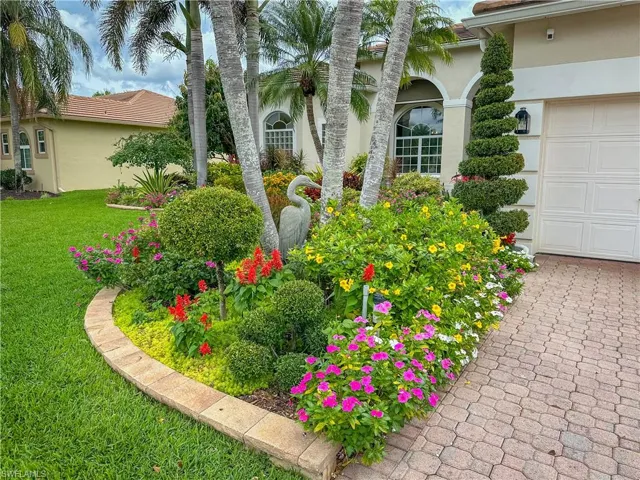View of grassy yard with a garage