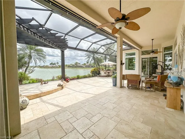 View of patio / terrace with a lanai, a sunroom, ceiling fan, a water view, and outdoor lounge area