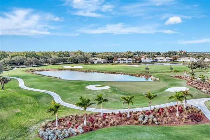 View of community with a water view, view of golf course, and a yard