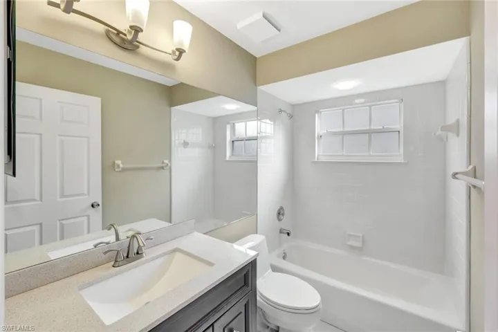 Full bath featuring vanity and shower / bath combination