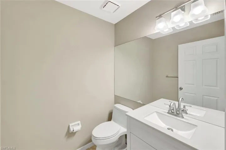 Half bath with vanity and toilet
