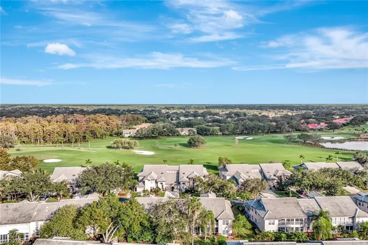 Aerial perspective of suburban area with a local golf course and a tree filled landscape