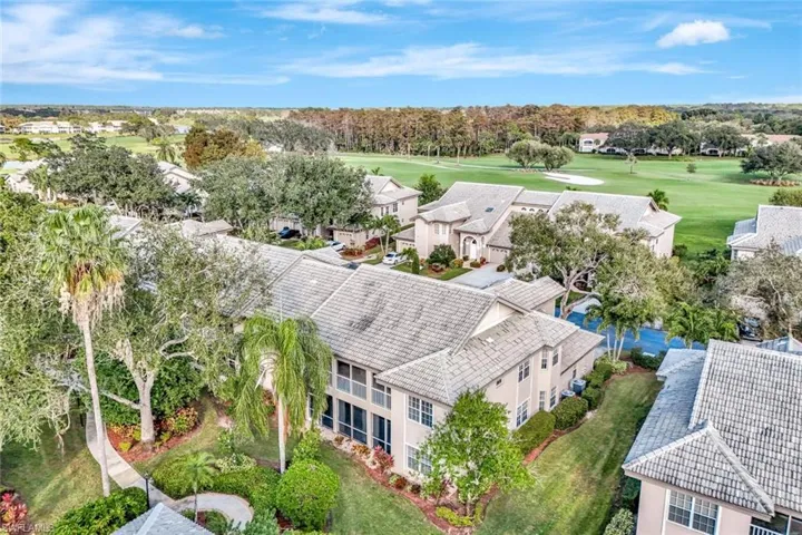 Aerial perspective of suburban area featuring a tree filled landscape and a local golf course