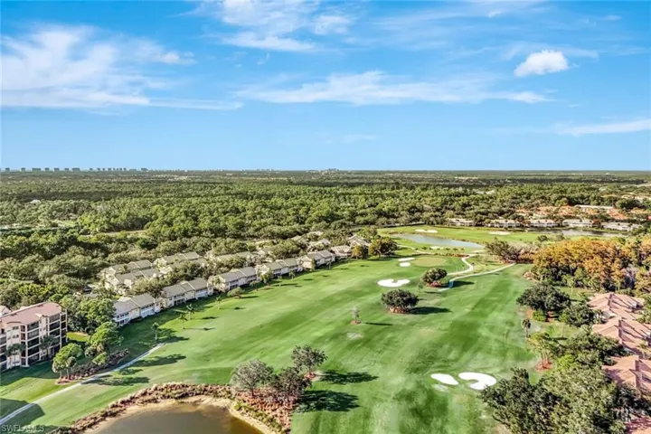 Aerial view of residential area with a large body of water and a golf course