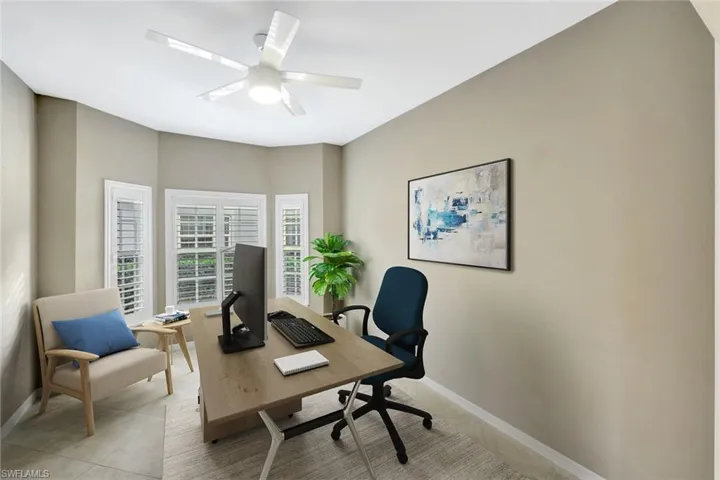 virtually staged Office space with a ceiling fan and light tile patterned floors