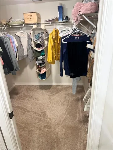 Primary bedroom walk-in closet