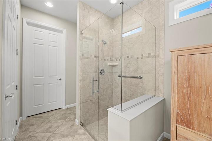 Large step in shower, linen closet just behind shower