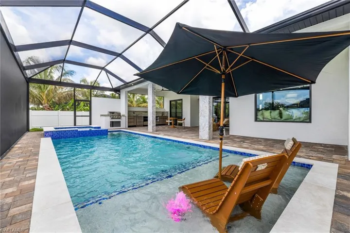 Who needs to go on vacation when I can spend time in my own pool at my own house! Now.... This is the Living the Florida Lifestyle! You can even use this sun shelf for the little ones.... Just take out the loungers and the Umbrella. Pebble finish with Glass tiles this Heated Saltwater pool/spa is amazing and it has a Hayward Smart System! Variable high speed pump.