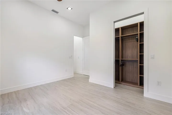 This closet is larger than it looks! Bedroom is spacious with custom light filtering shades, ceiling fan with remote recessed lighting and tall ceilings. This builder did this right!