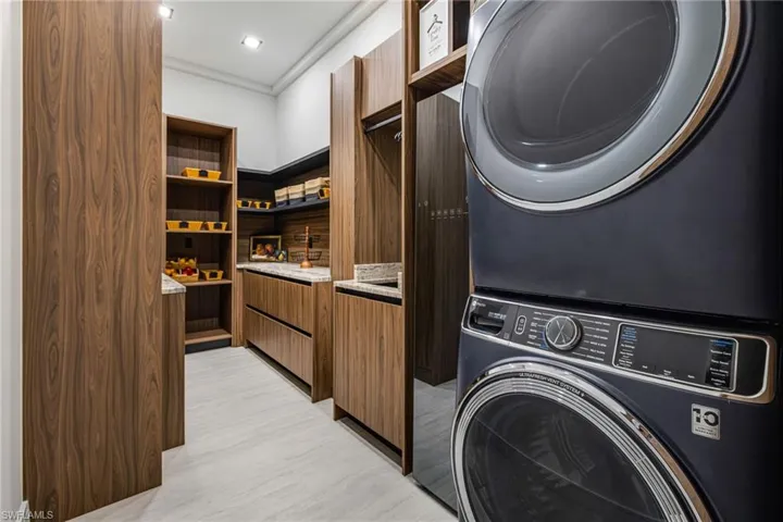Ok..... This laundry room/ Pantry.... I was Speechless! A FULL Sized Front Loading GE washer and Dryer, A Stand Alone Steamer (No Ironing??) Laundry Sink with hanging rod and storage for Brooms, mops vacuum and all the detergents and cleaners!!!!