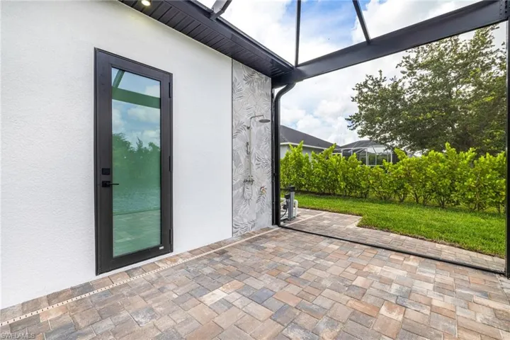 Outdoor Tiled shower and there's a spigot for your house to allow you to clean without leaving the screen door open. Extra area for sunning!
