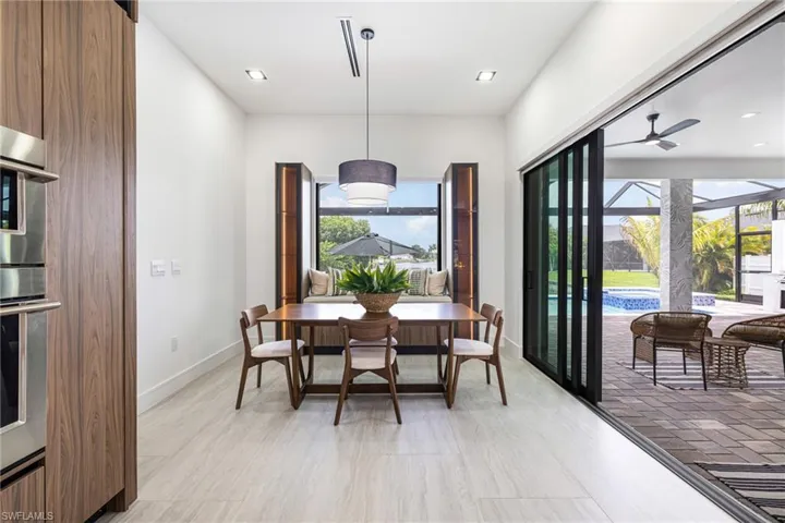Does that Dining Room have a Built in Bench with custom drawers and Seating? Over looking the Canal and the Pool? LED Lighted Glass Cabinets with Custom Light filtering shades? YES! and you can use the bench as a reading nook too! Beautiful!