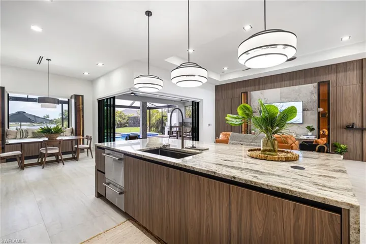 Upgraded Kitchen fixture with a Cup washer! Pop up phone chargers and Cabinets with no handles??? Wow this one is amazing!