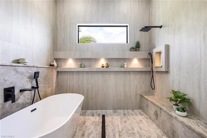 Now.... This is a Proper PRIMARY Bathroom! Look at that oversized bench with Granite, the Niches with the LED Lights, the Soaking Tub with the Modern spout and wand to assist with easy cleaning, 2 Rain styled Shower heads and hand held wands. Where are we in an upgraded penthouse?