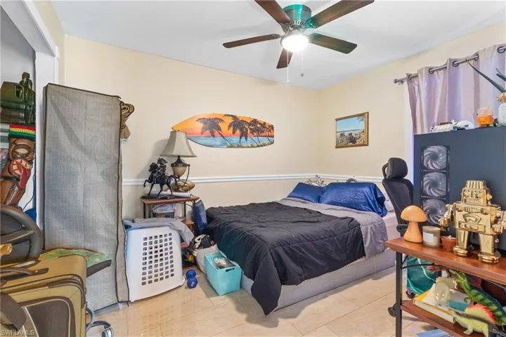 Tiled bedroom with ceiling fan