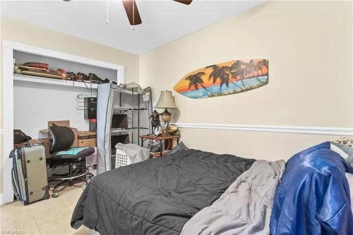 Tiled bedroom with ceiling fan