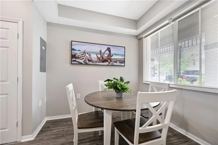 Dining area featuring dark wood finished floors and electric panel