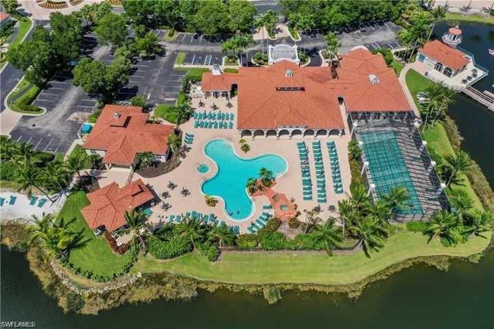 Aerial overview of property's location featuring a pool area and a nearby body of water