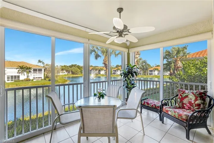 Sunroom / solarium featuring a water view and tile patterned floors