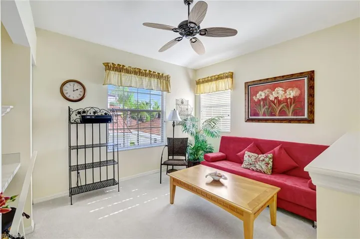 Living room featuring carpet and ceiling fan