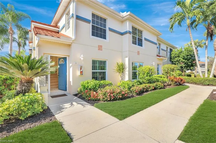 View of front of home with stucco siding and a front yard
