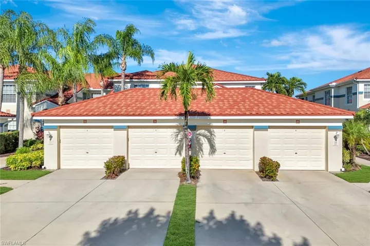 Mediterranean / spanish-style home featuring a tile roof, stucco siding, and community garages