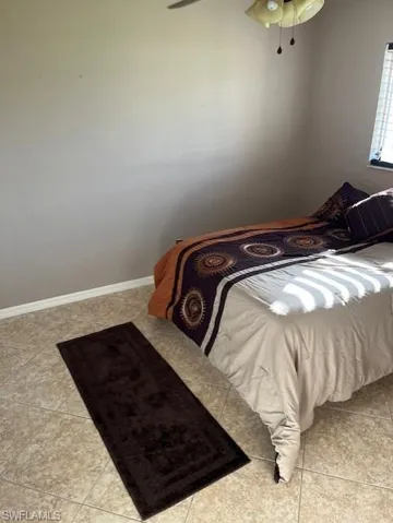 Tiled bedroom with ceiling fan