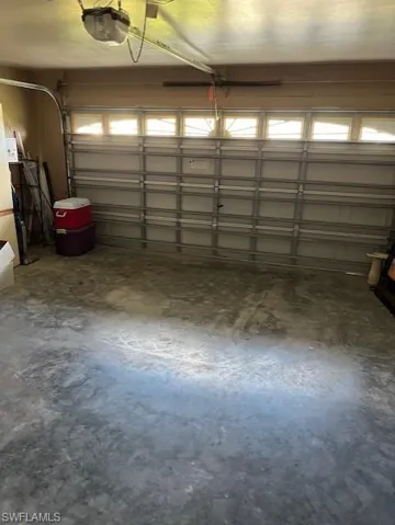 Garage featuring a garage door opener