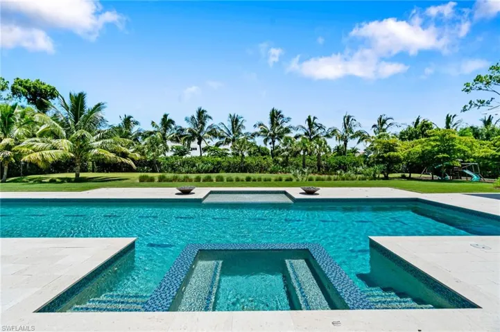 View of swimming pool featuring an in ground hot tub