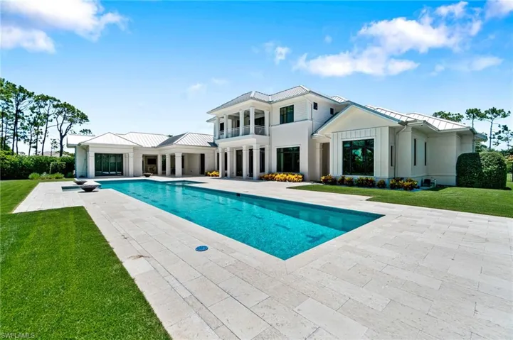 View of pool featuring a patio and a lawn