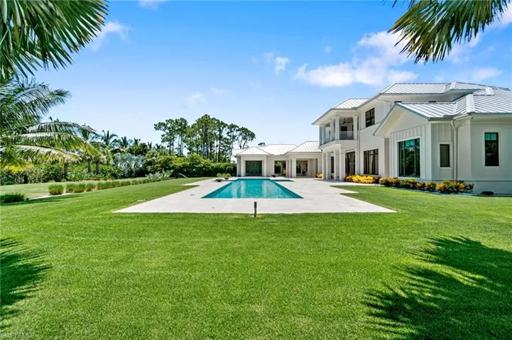 View of pool with a patio and a lawn