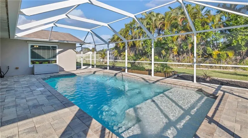 Outdoor pool featuring a lanai, a sunroom, and a patio