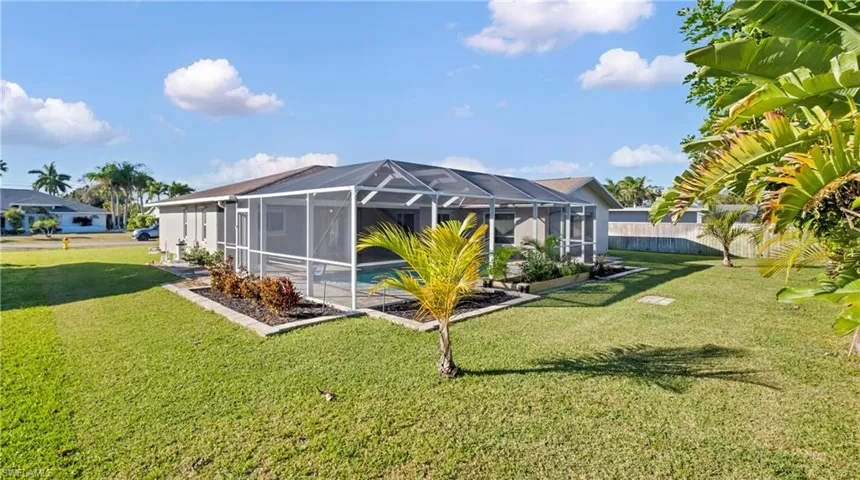 Rear view of house featuring a lanai and a sunroom
