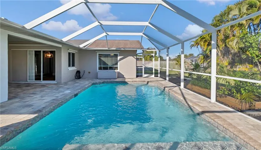 Outdoor pool featuring a lanai, a patio area, and a sunroom