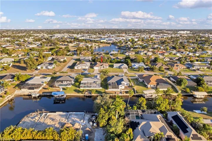 View of property location featuring a large body of water and nearby suburban area