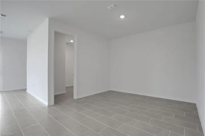 Unfurnished room with baseboards and recessed lighting