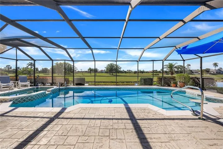 Massive Pool Cage Shows off Panoramic Water Golf Course View