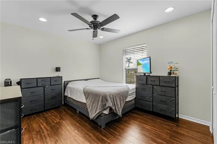 Bedroom with wood finished floors, recessed lighting, and a ceiling fan