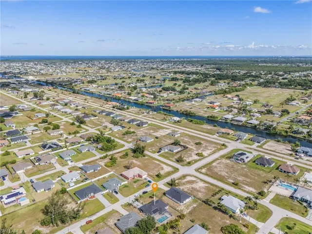 Aerial view of property's location with nearby suburban area and a large body of water