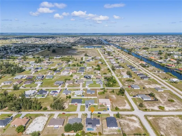 Aerial perspective of suburban area with a large body of water