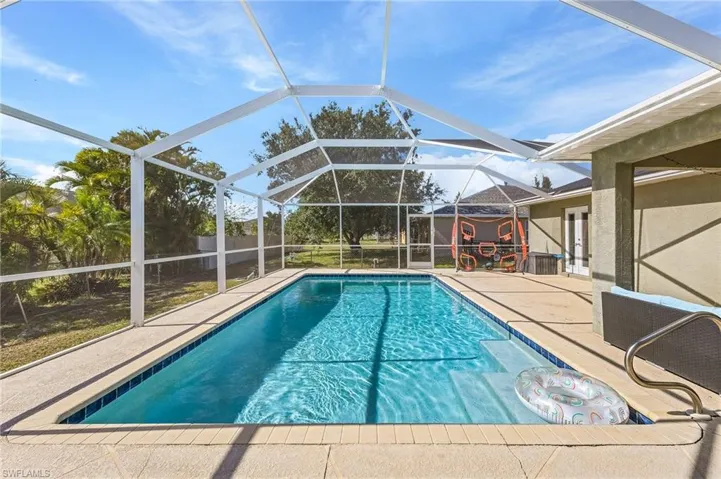 Swimming pool featuring a patio area and a lanai