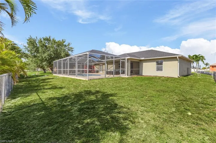 Back of house featuring an outdoor pool, stucco siding, a lanai, and a patio