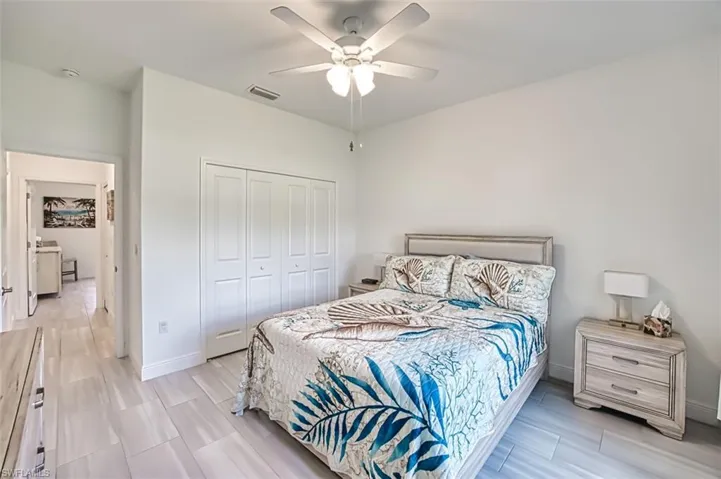 Bedroom with ceiling fan and a closet