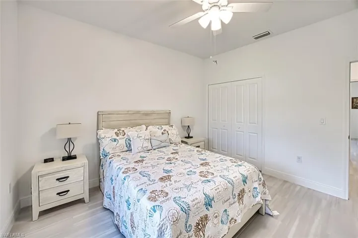 Bedroom featuring a closet, a ceiling fan, and light wood finished floors