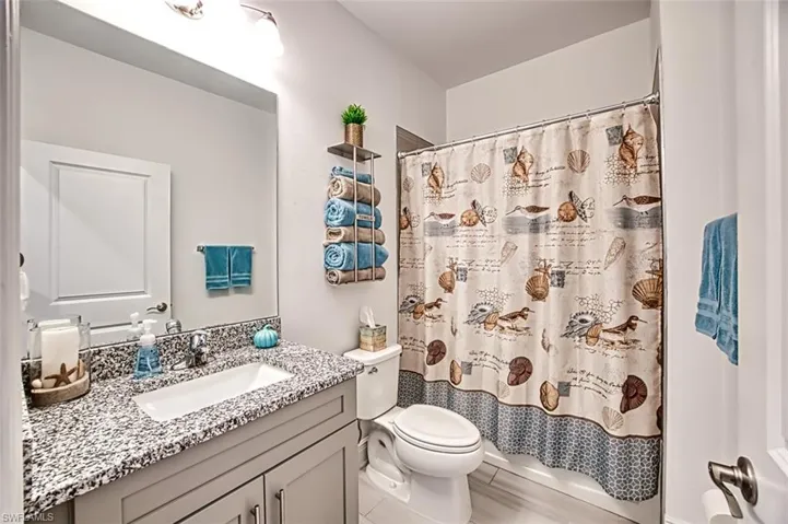 Full bathroom with vanity and light wood finished floors
