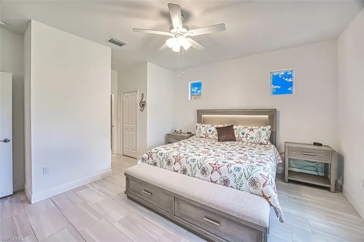 Bedroom featuring a ceiling fan and wood tiled floors