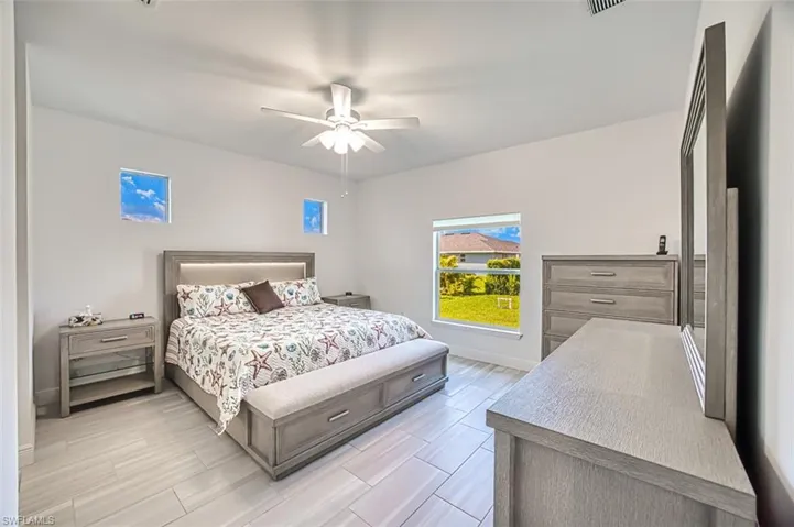 Bedroom featuring ceiling fan and wood tiled floors