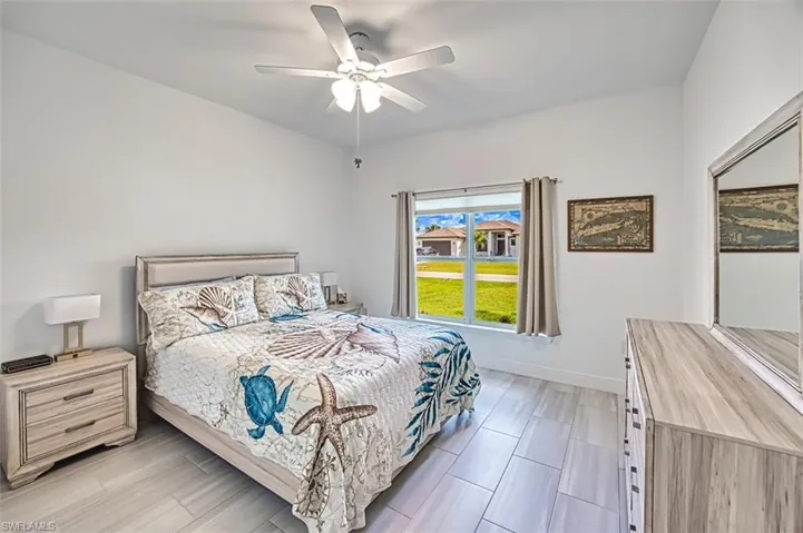 Bedroom with ceiling fan and wood tiled floors