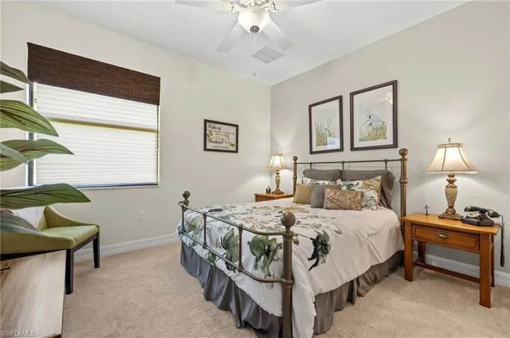 Carpeted bedroom with ceiling fan