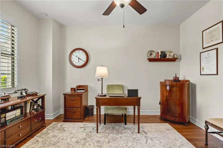 Office with ceiling fan, hardwood / wood-style floors, and a healthy amount of sunlight